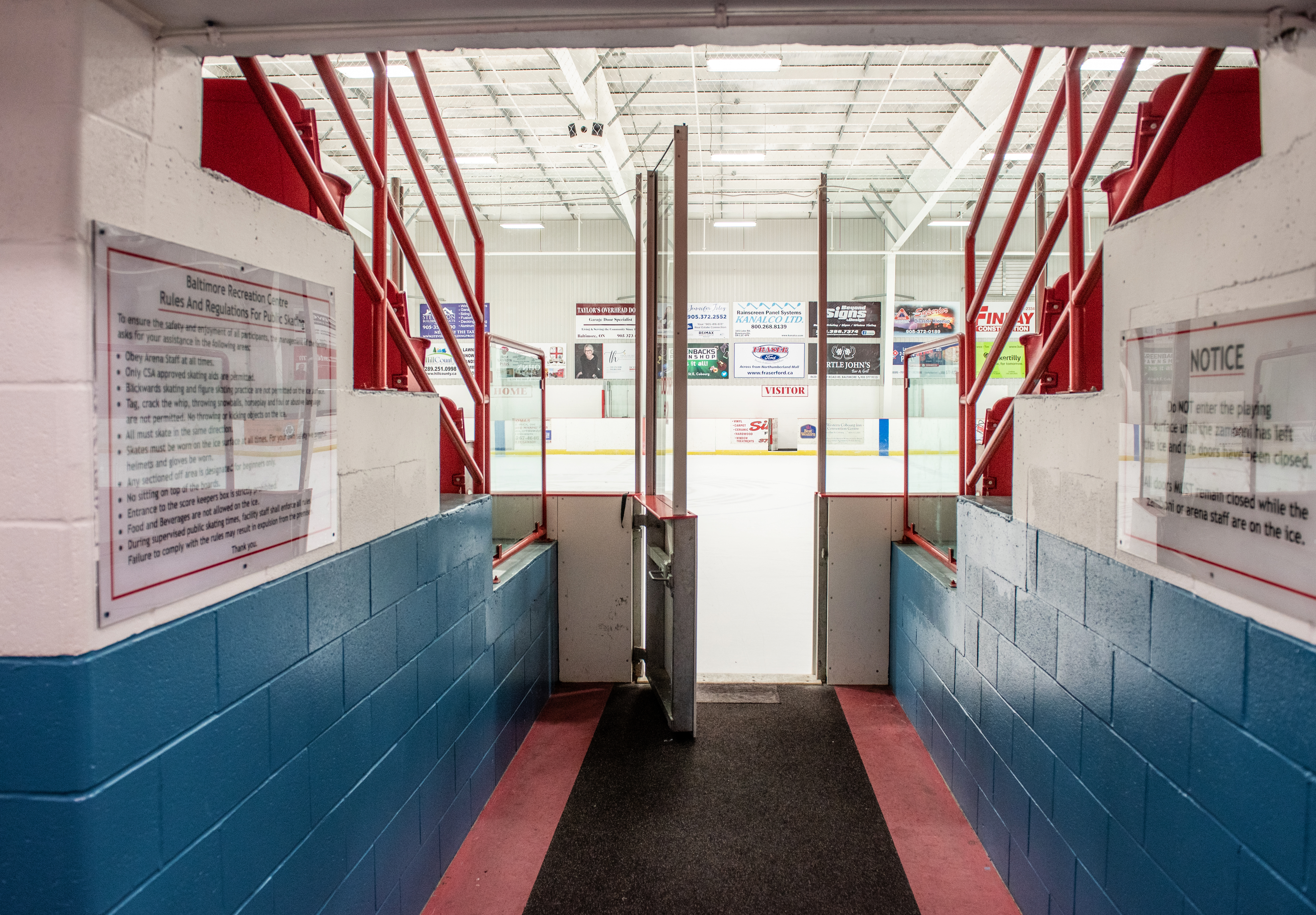 Baltimore arena ice rink from the entrance between bleachers with rules and regulations notices visible